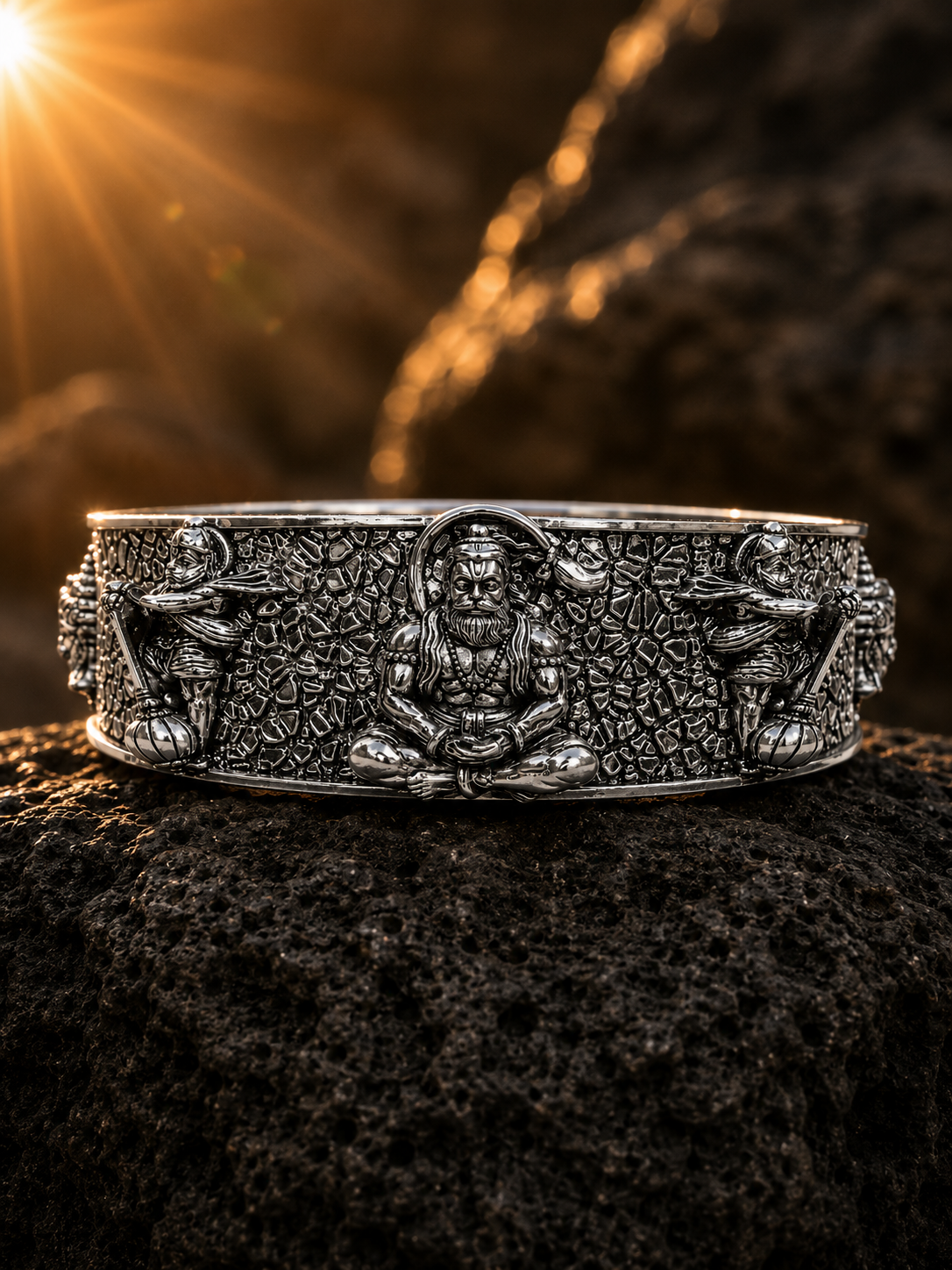 Silver bracelet with intricate designs on a dark textured surface