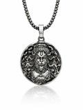 Silver pendant with intricate design on a chain against a white background